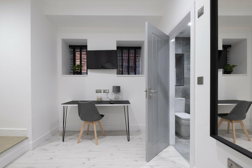 Bright, minimal workspace with a sleek desk, co...