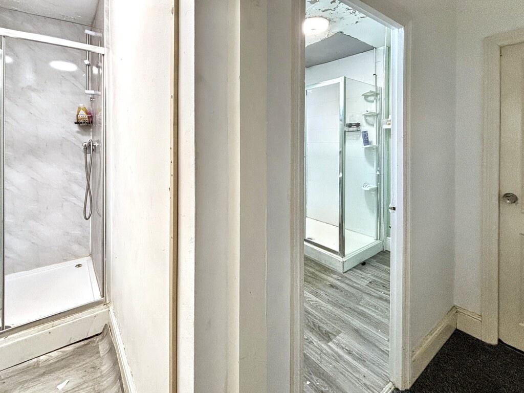 A clean and well-lit spacious bathroom with a l...