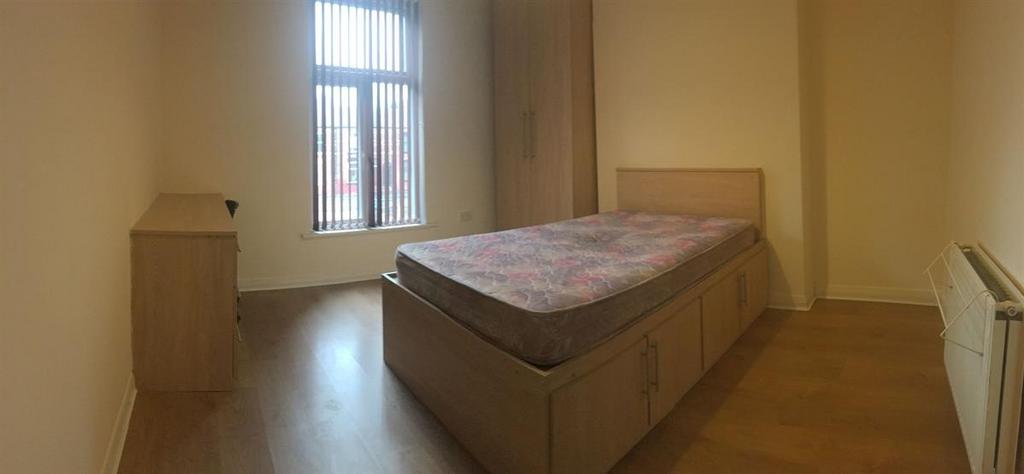 Bright, simply furnished bedroom with a raised ...