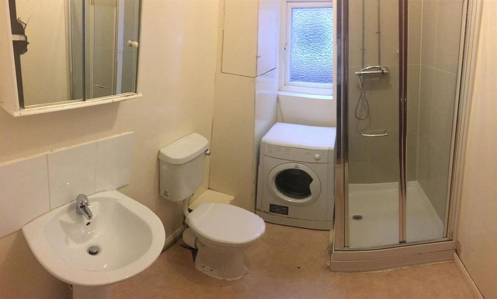 Well-kept bathroom with a pedestal sink, toilet...