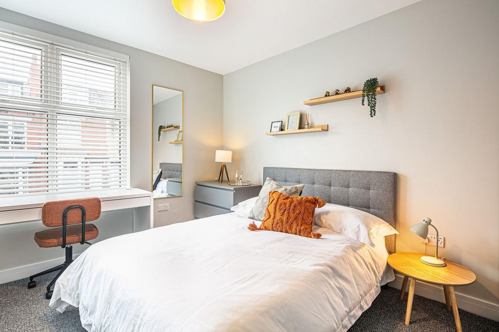 Bright and modern double bedroom featuring a la...