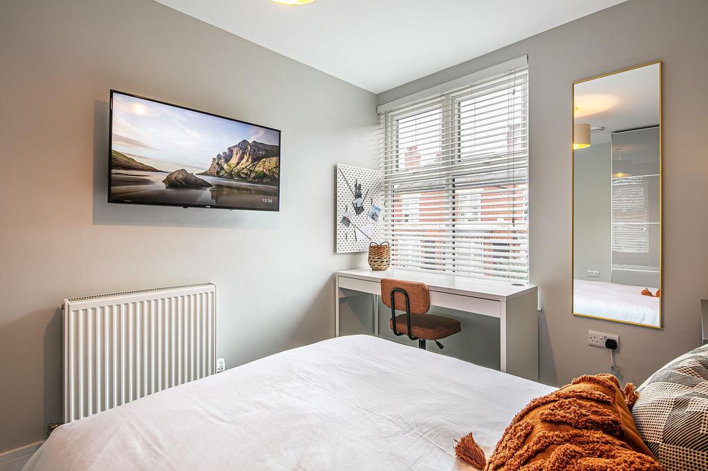 Bright and welcoming double bedroom featuring a...