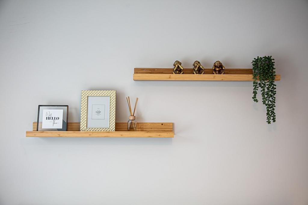 Minimal decorative wall shelves with framed pri...