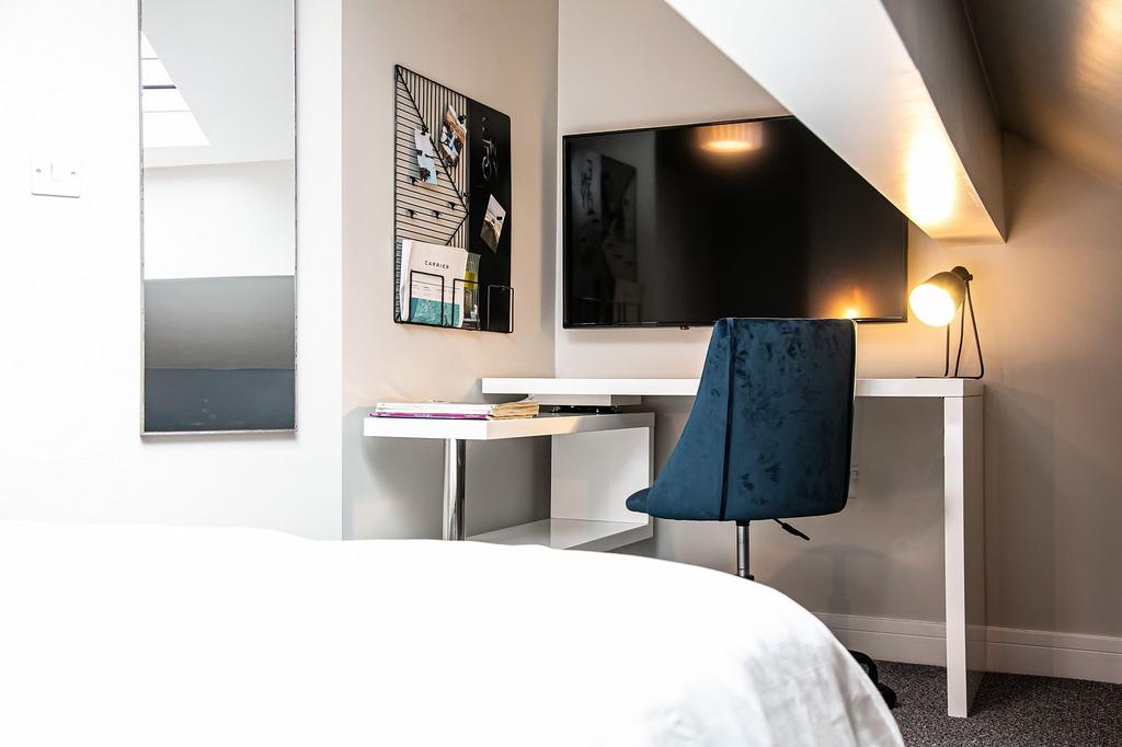 A modern bedroom featuring a cozy layout with a...