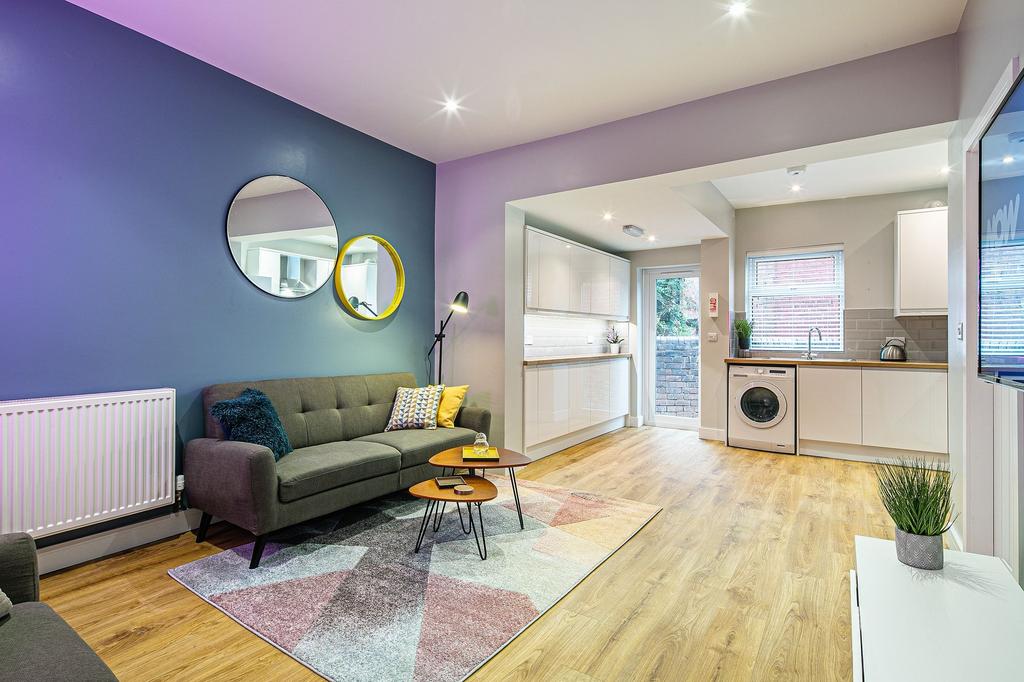 A bright and modern living room with a cozy gre...