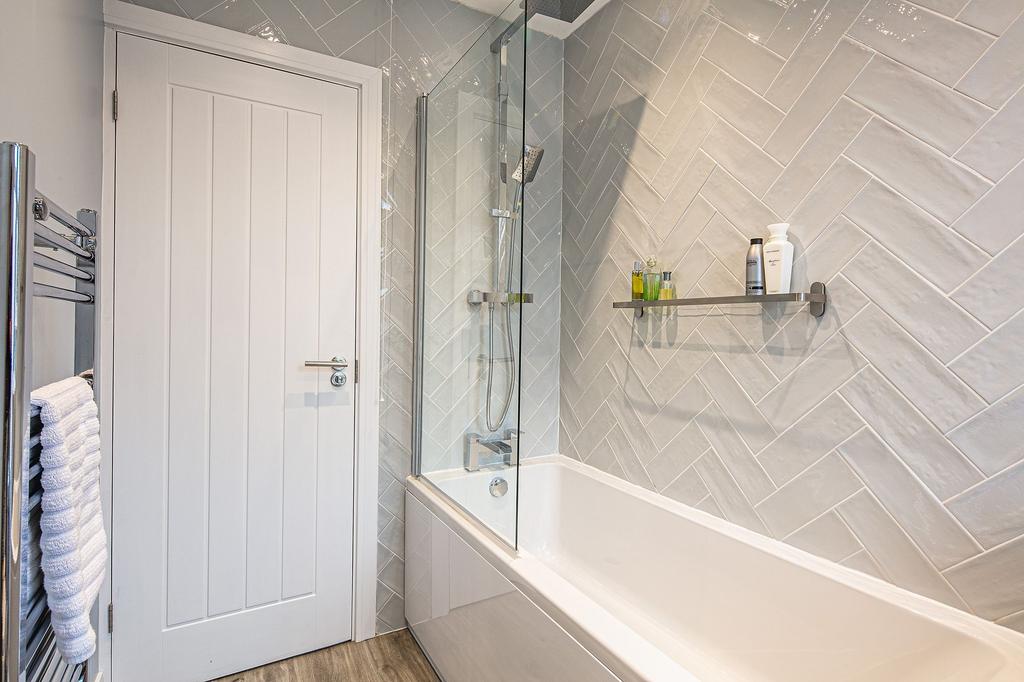 Modern bathroom with a spacious bathtub, sleek ...