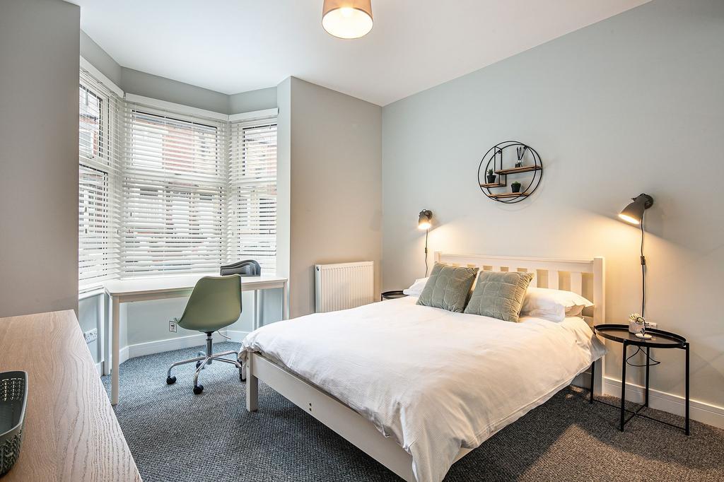 Bright and modern bedroom featuring a comfortab...