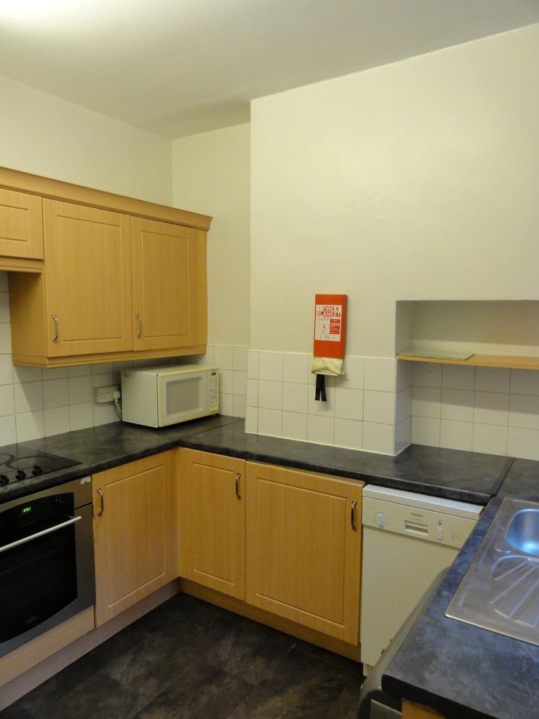 A well-maintained kitchen featuring wooden cabi...