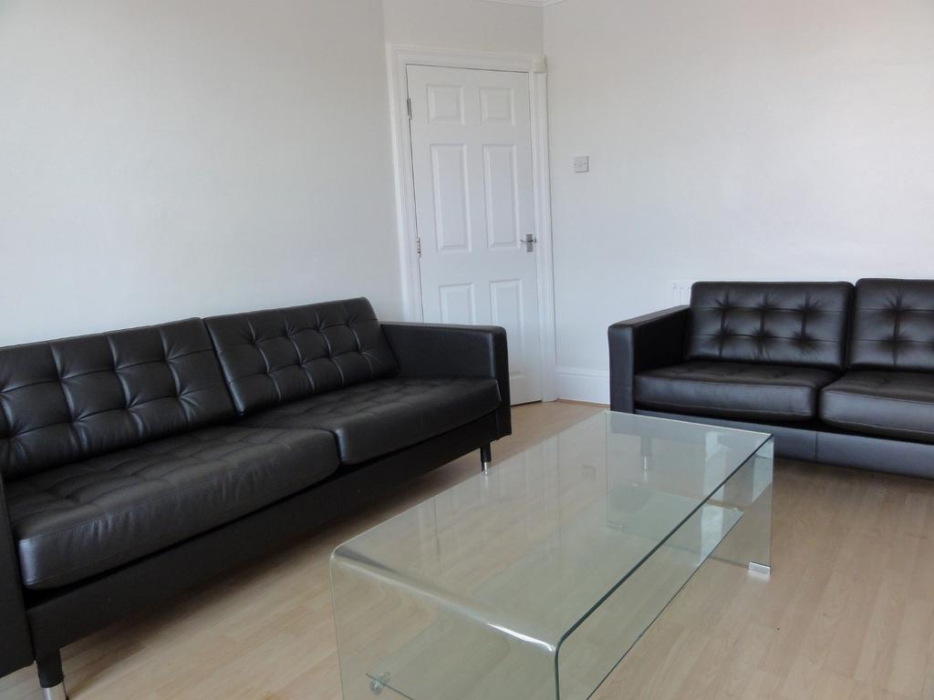 Modern living room featuring two black leather ...