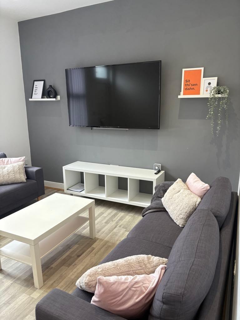 Contemporary living room with grey sofas, pale ...