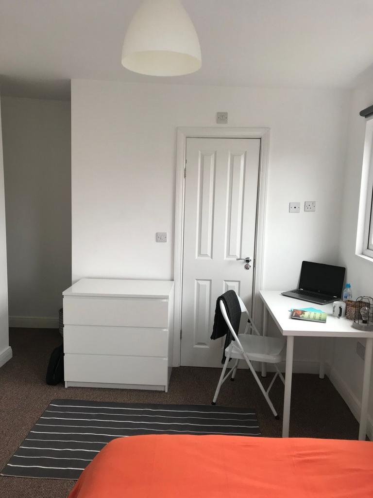 Bright, neatly presented bedroom with a simple ...