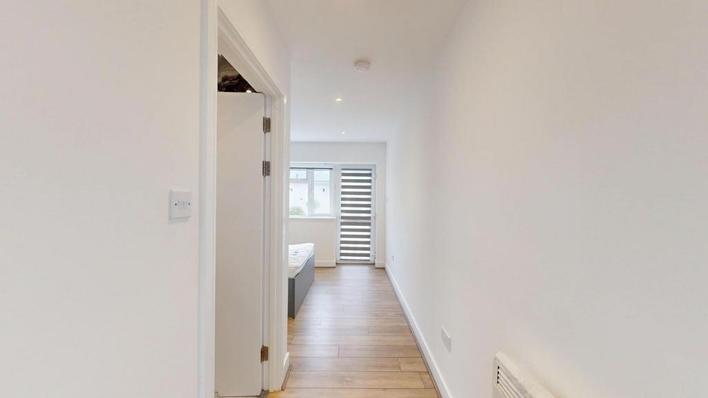 Bright, freshly painted hallway with wood-effec...