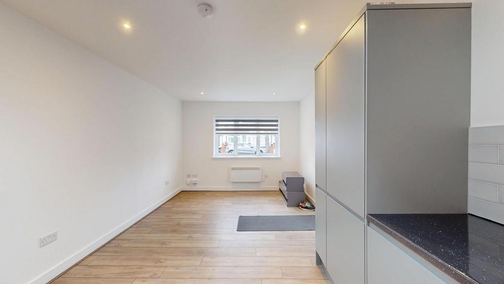 Bright, modern open-plan living area with reces...