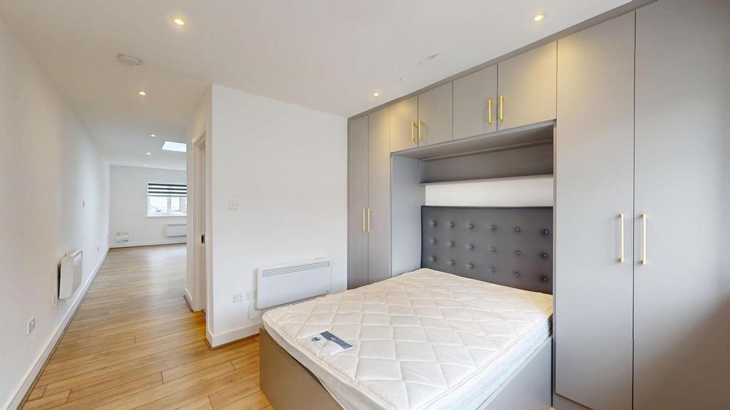 Bright, modern double bedroom with built-in war...