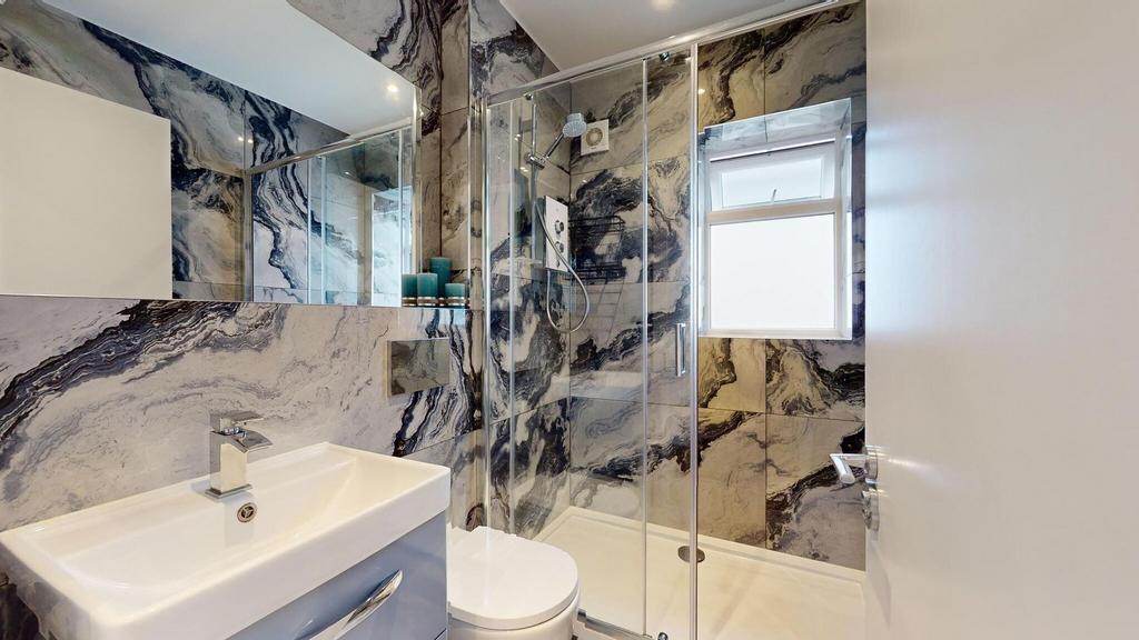 Stylish modern bathroom with a glass-enclosed s...