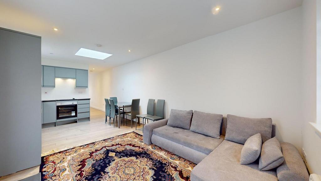 Bright open-plan living space with a large grey...