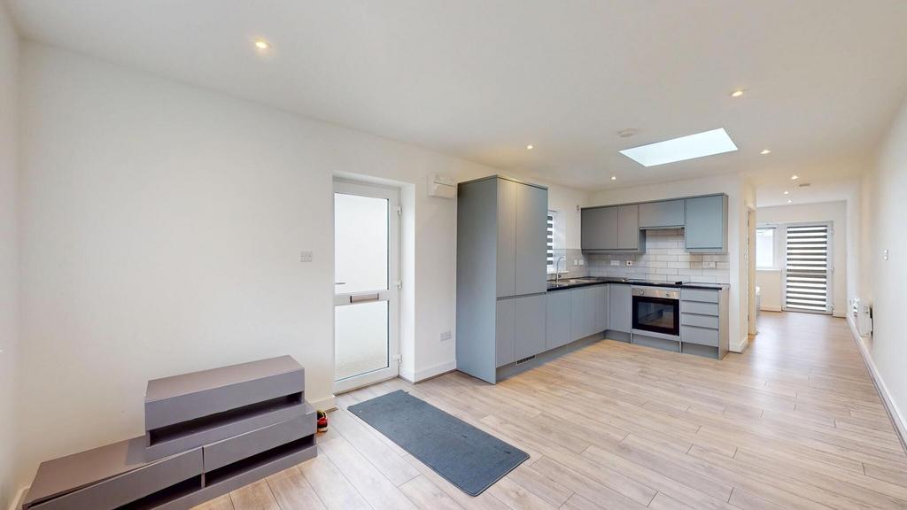 Bright, modern open-plan living area with a sle...