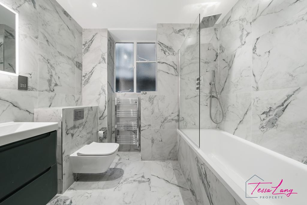 Bathroom with bath and overhead shower