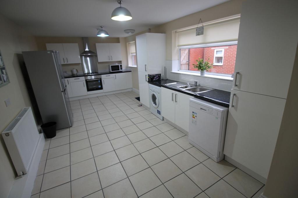 Bright, modern galley kitchen with plenty of st...