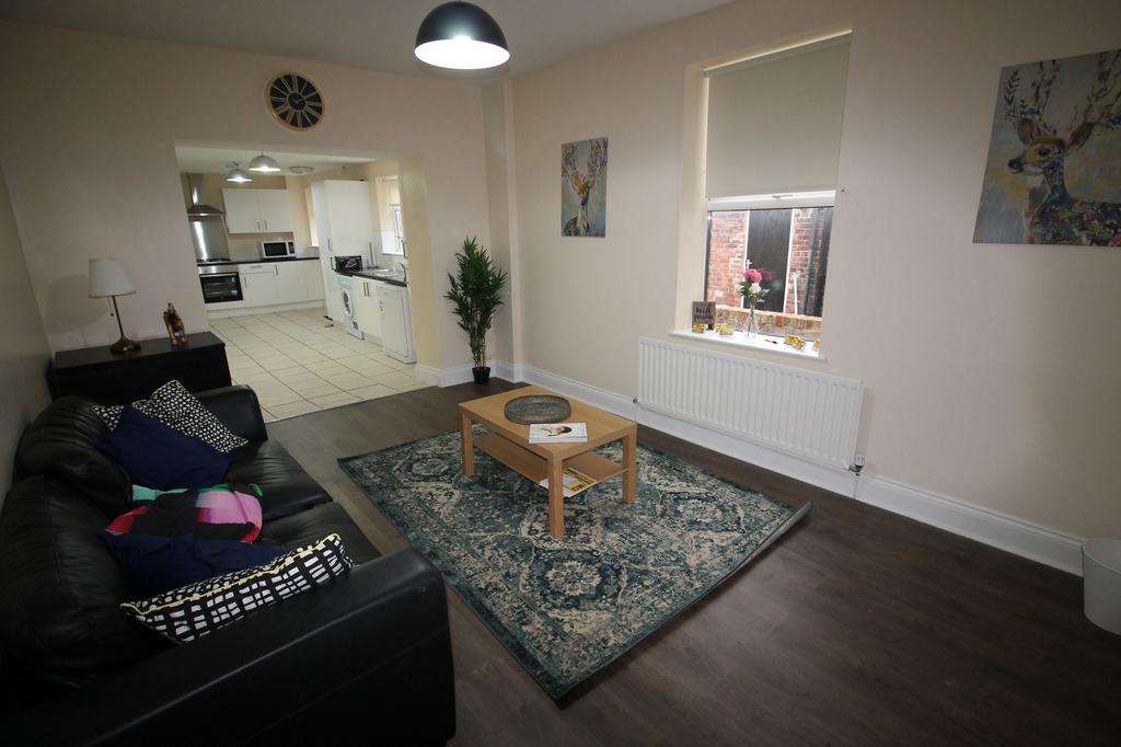Bright, open-plan living area with a comfortabl...