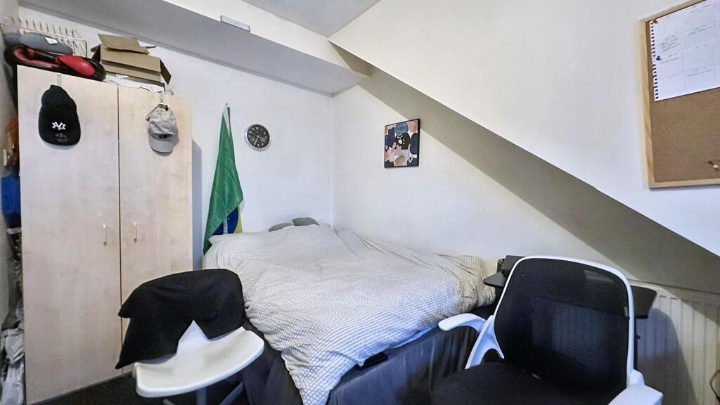 Cozy attic double bedroom with a comfortable do...