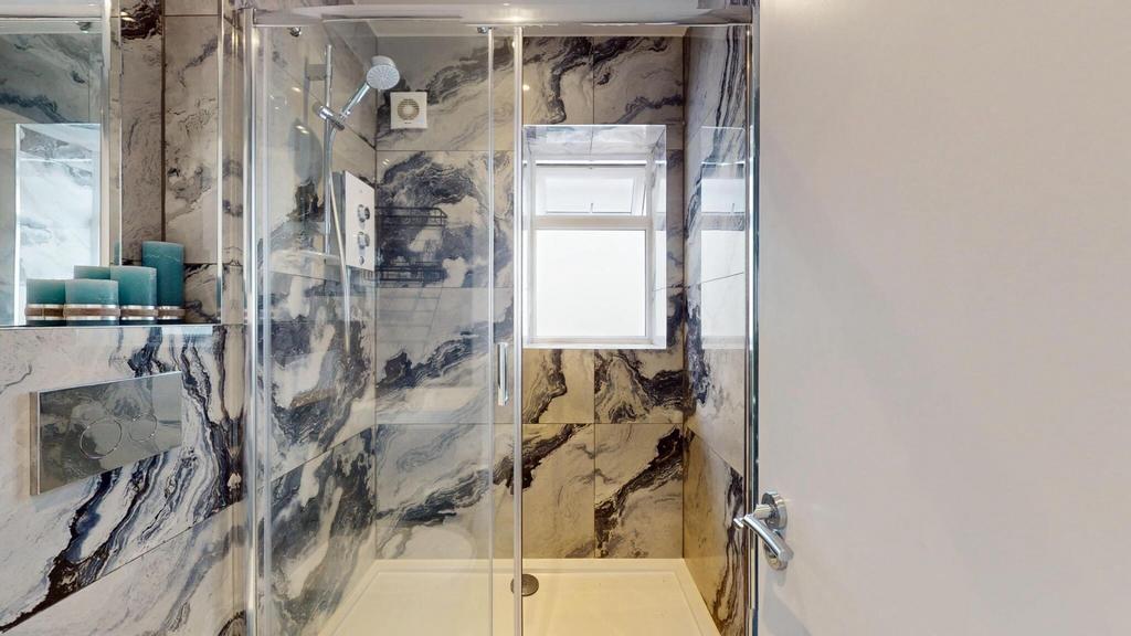 Modern bathroom suite with striking marble-effe...