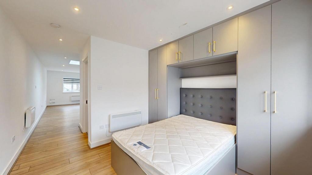 Bright, modern double bedroom with built-in war...