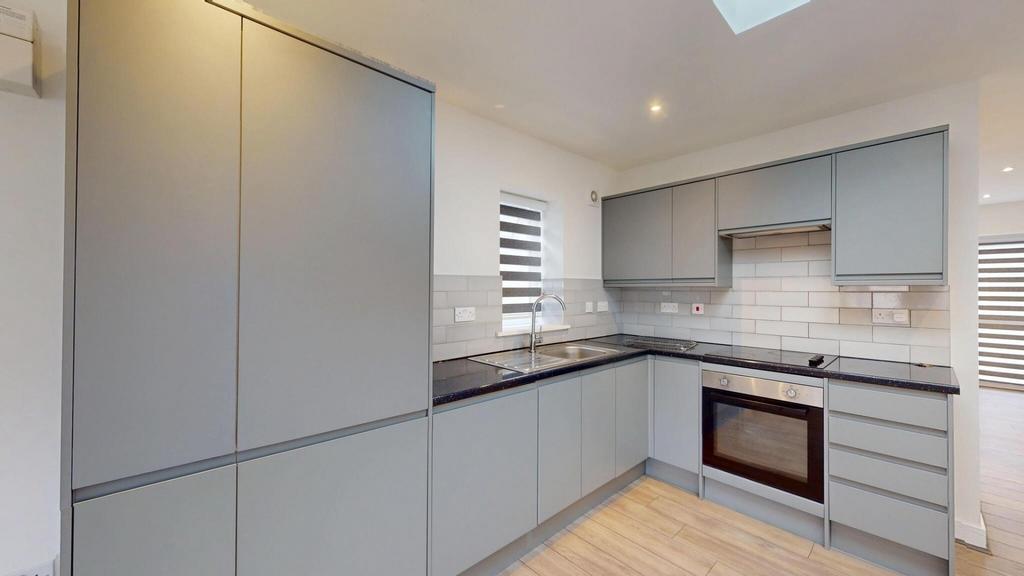 Modern fitted kitchen with sleek grey cabinetry...