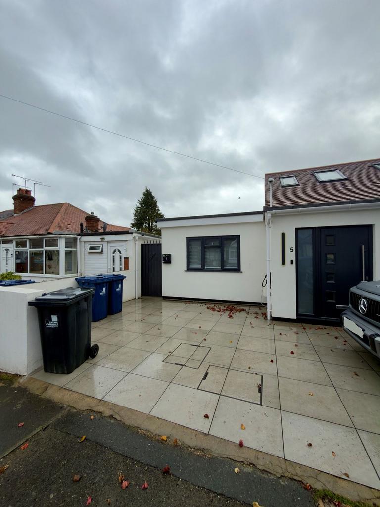 Contemporary front exterior with paved driveway...