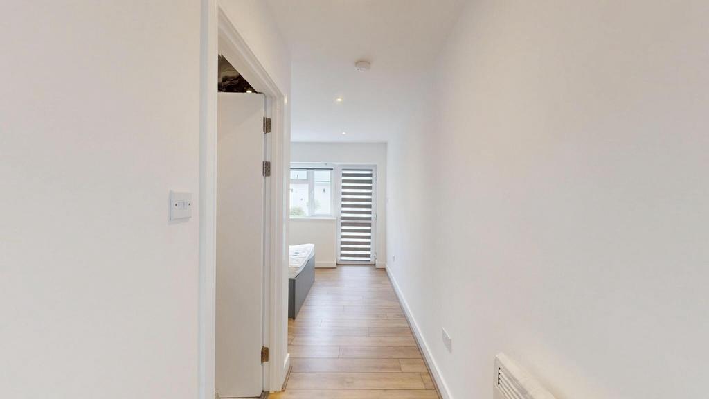 Bright, modern hallway with wood-effect floorin...