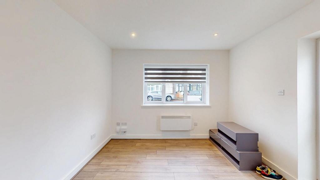 Bright, neutrally decorated room with wood-effe...