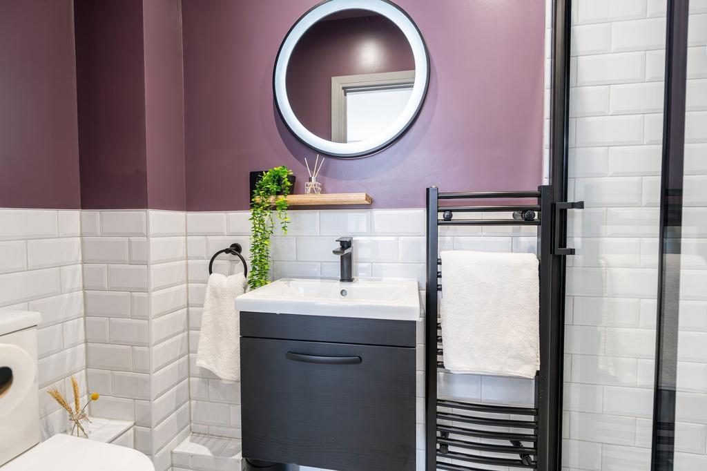 Modern bathroom featuring a stylish black vanit...