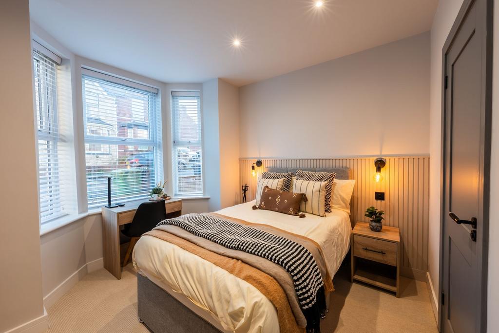 Bright, contemporary double bedroom with a cozy...