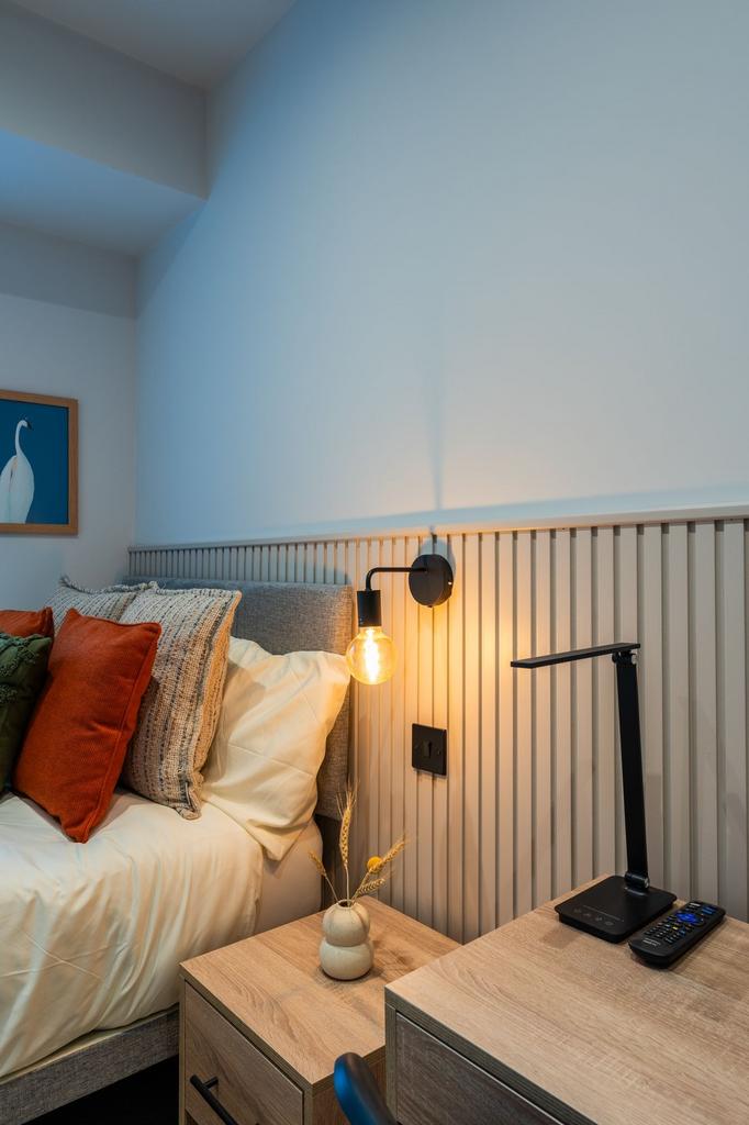 Bright, stylishly furnished bedroom corner with...