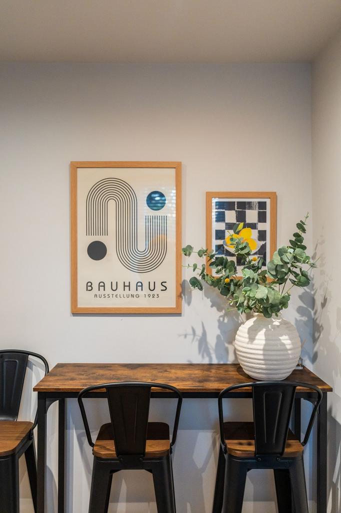 Stylish study nook with a warm wooden high tabl...