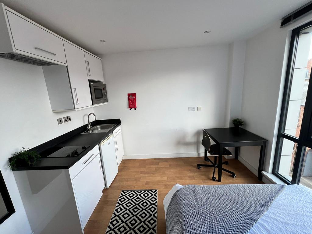 Bright modern studio-style room with a compact ...