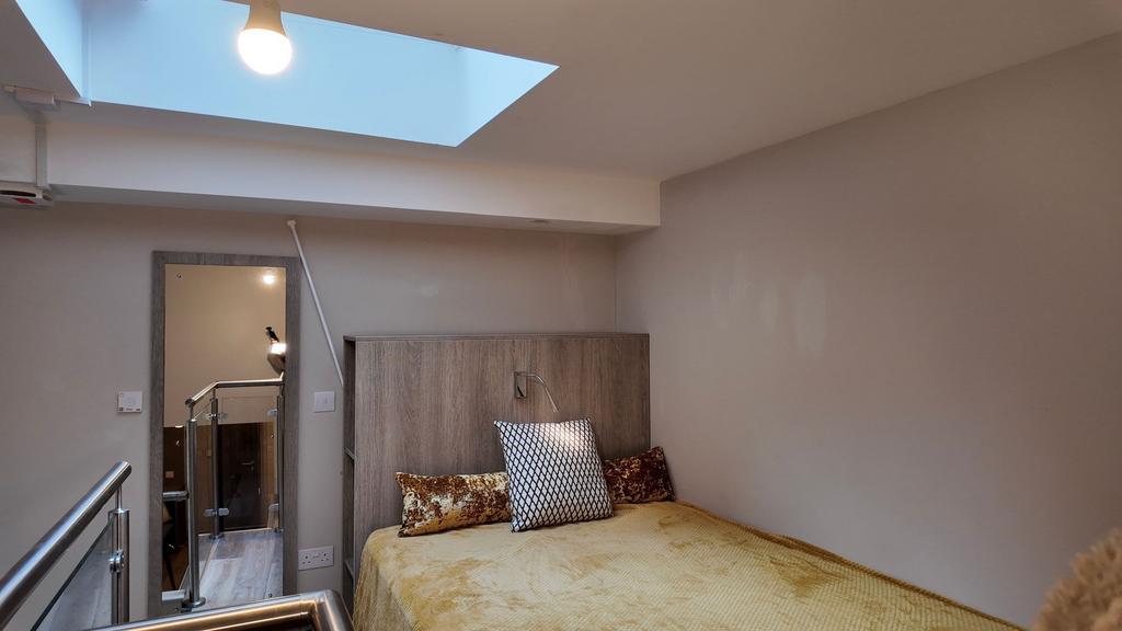 Cozy bedroom with a warm-toned bed, stylish hea...