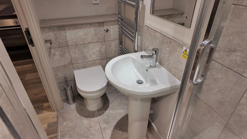 Well‑finished bathroom with tiled walls and flo...