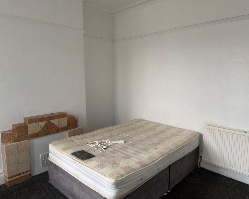 Bright, simply-fitted bedroom with a double div...