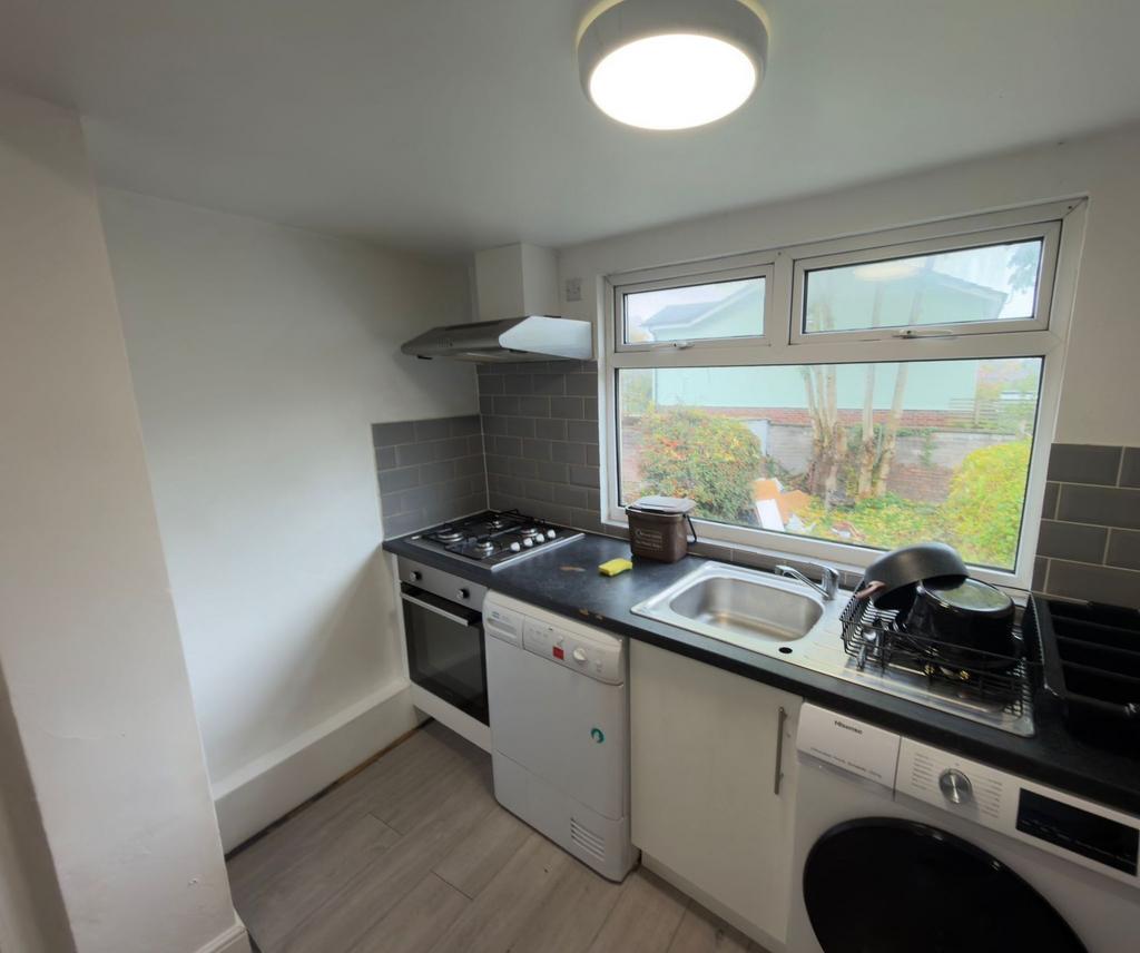 Bright modern kitchen with a large window over ...