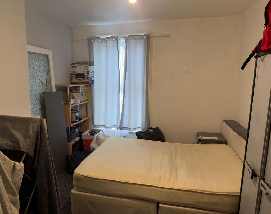 Bright bedroom with a large bed centered under ...