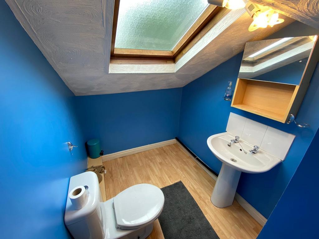 Bright, modern bathroom with bold blue walls, w...
