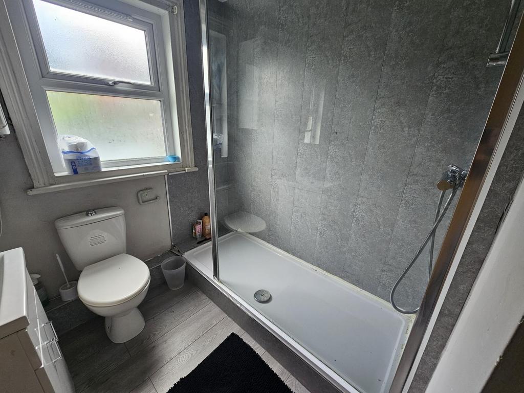 Modern bathroom with white suite, combined bath...