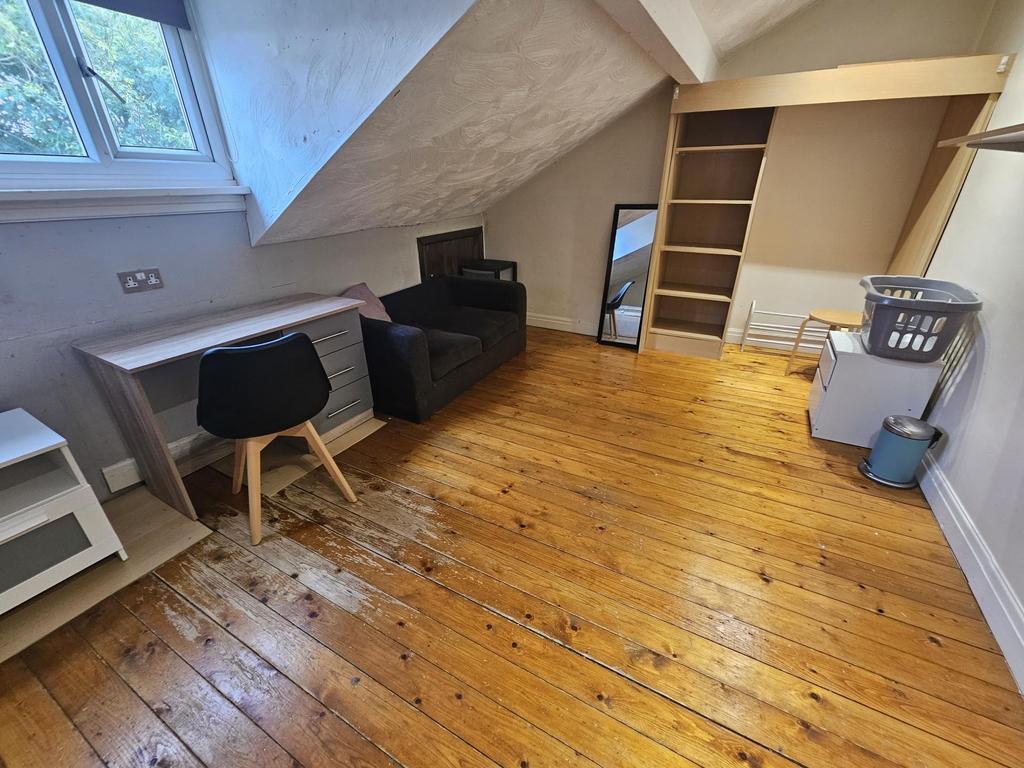 Bright attic-style double bedroom with polished...