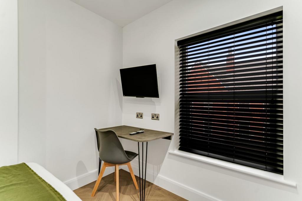 Bright, modern bedroom featuring a window with ...