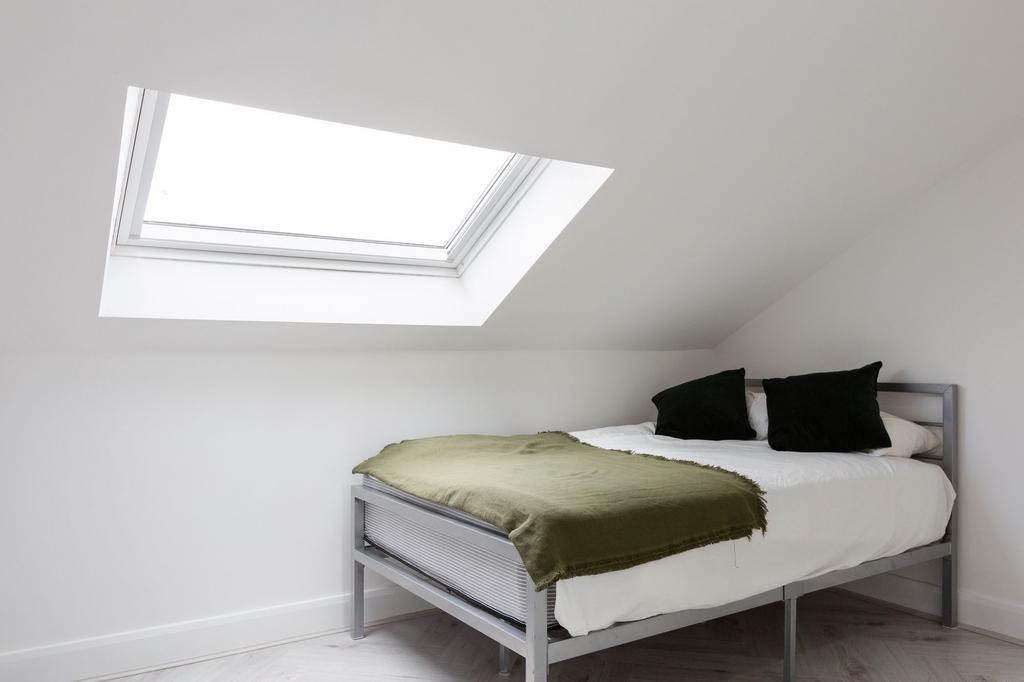 A bright and minimalist single bedroom featurin...