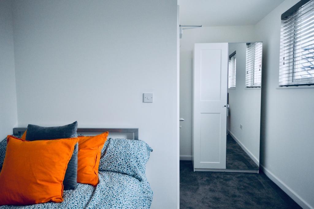 A bright, inviting bedroom featuring a comforta...