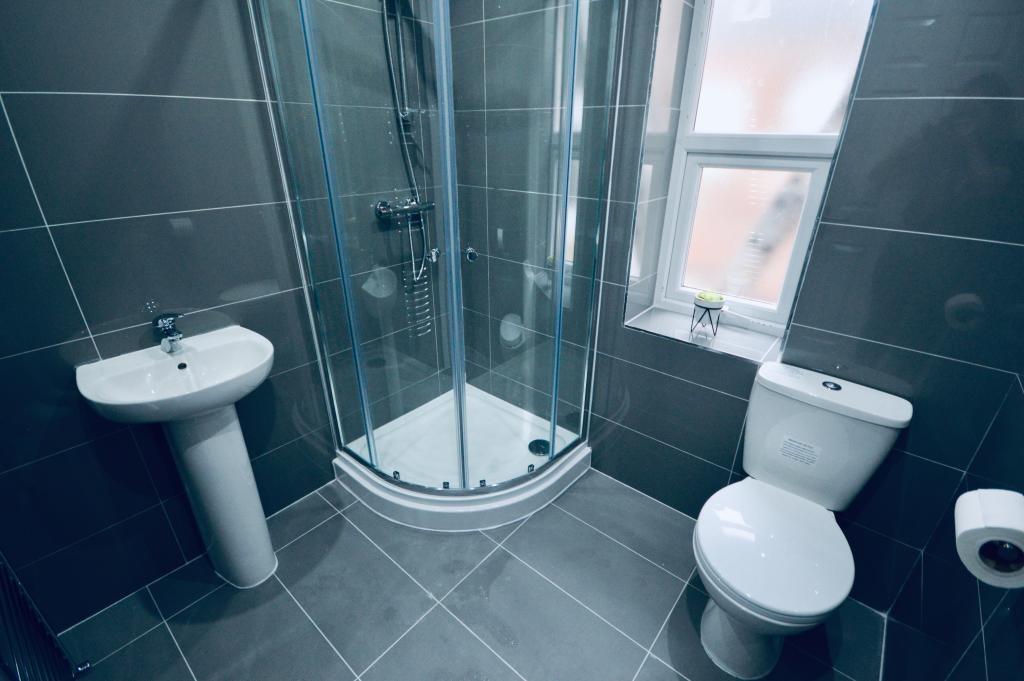 Modern bathroom with a shower enclosure, toilet...