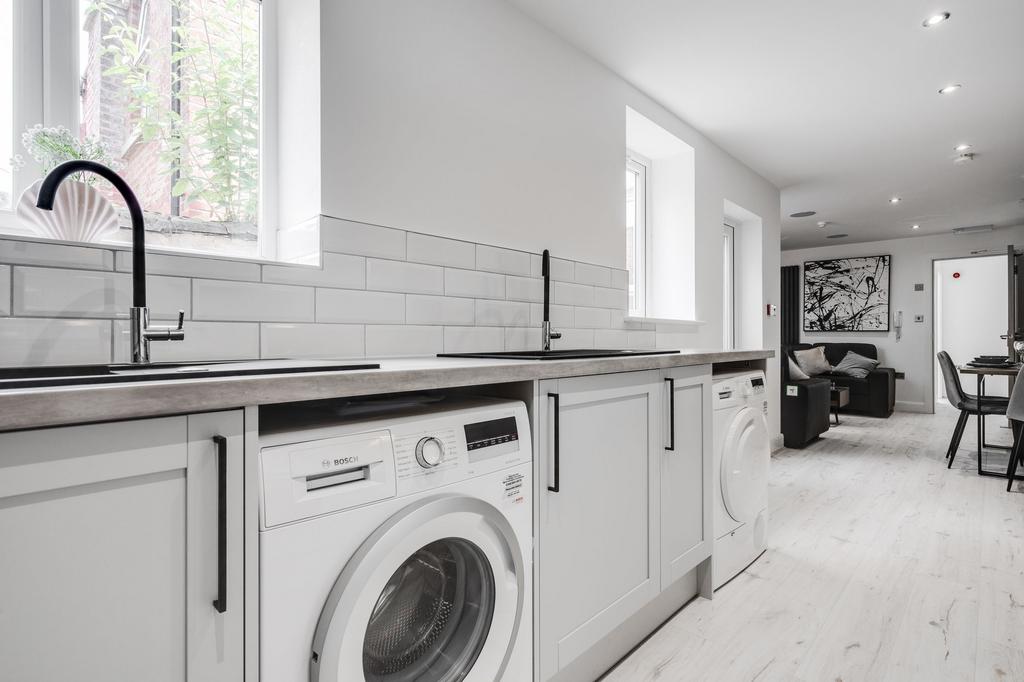 Modern and bright kitchen with clean, white cab...