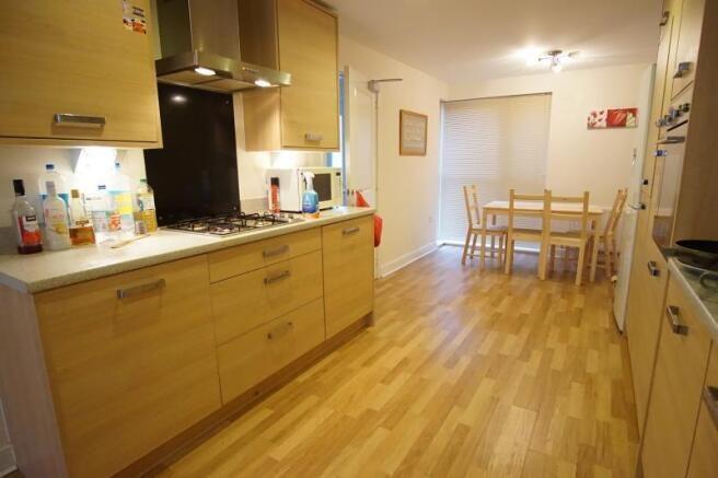 A bright and modern kitchen with ample storage ...